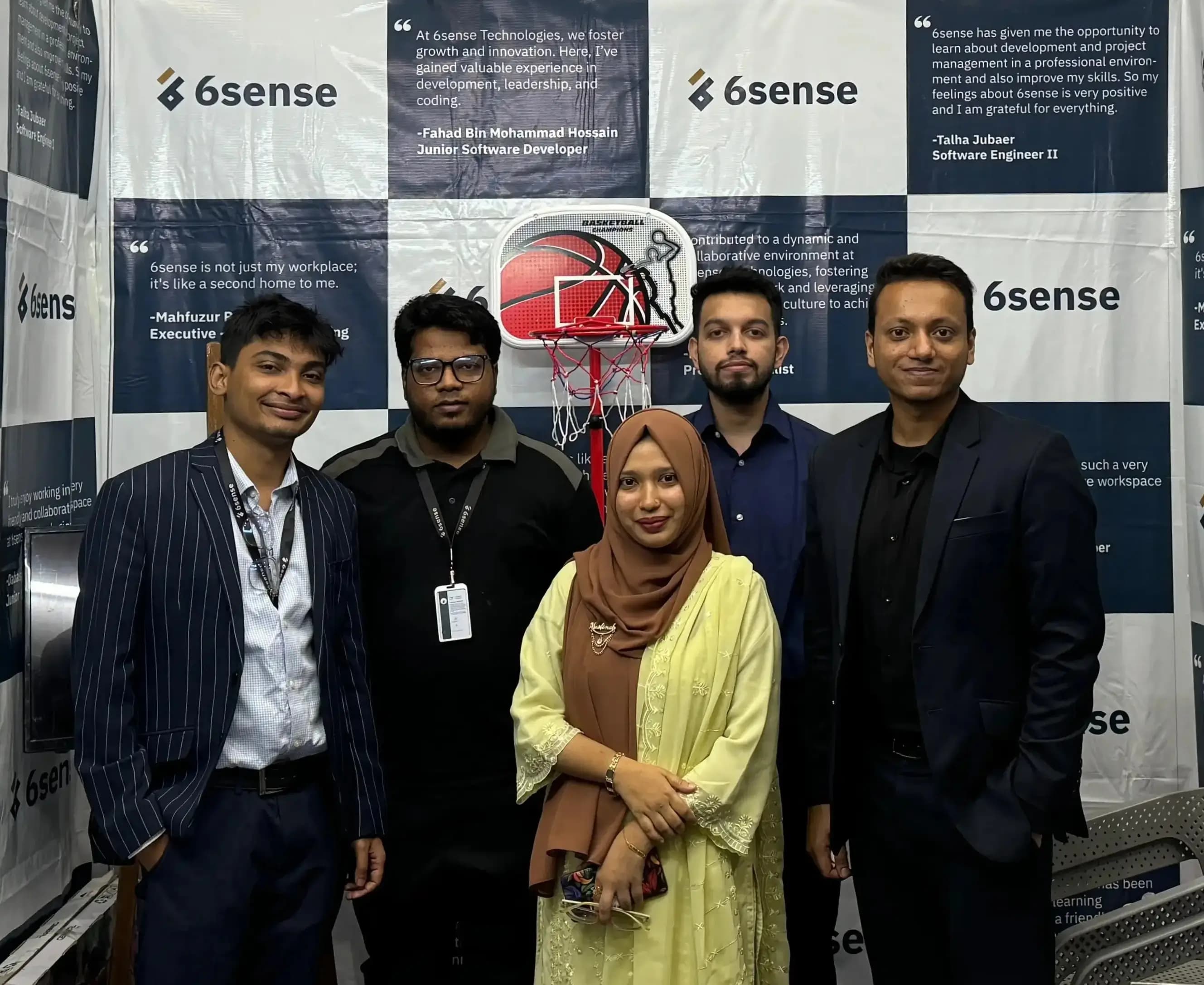 Five 6sense HQ team members standing at the company’s branded career fair booth.