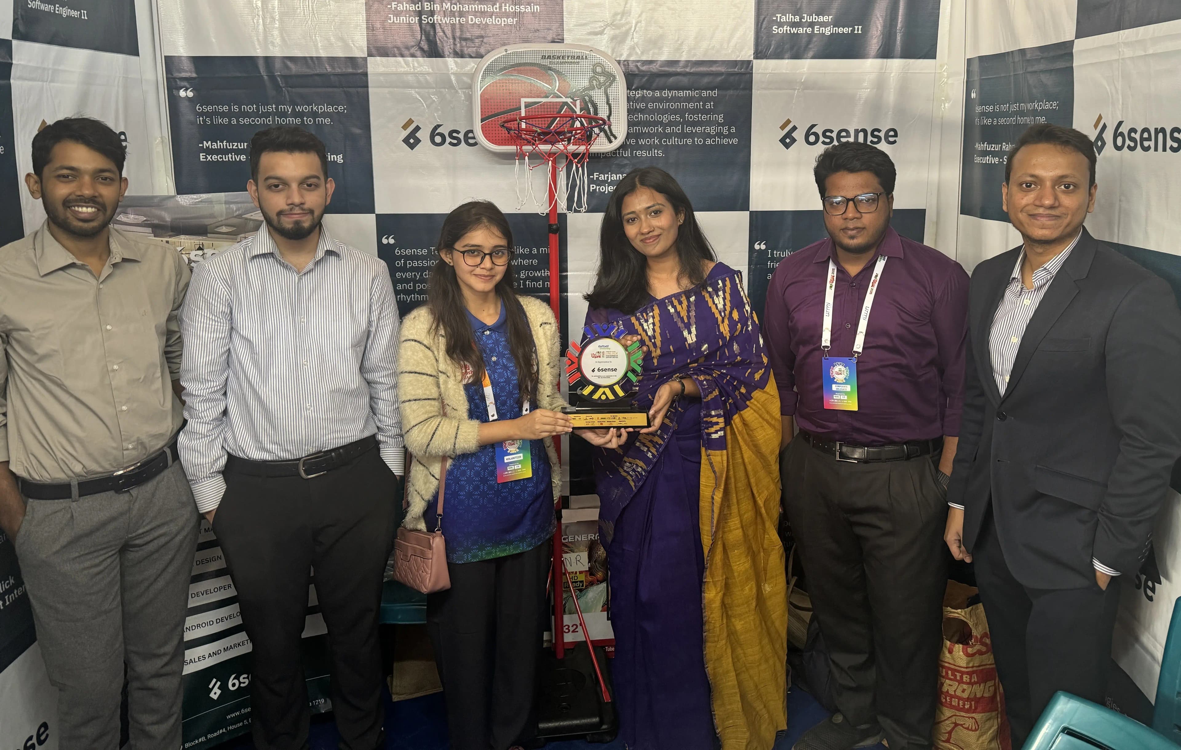 6sense HQ team members holding an award at the company booth during a university career fair.