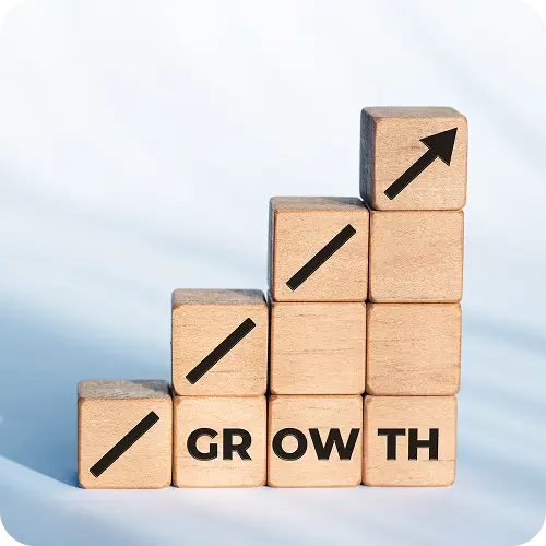 Wooden blocks stacked like stairs spelling growth