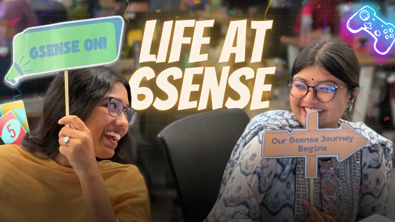 6sense HQ teammates holding “Life at 6sense” signs in the office