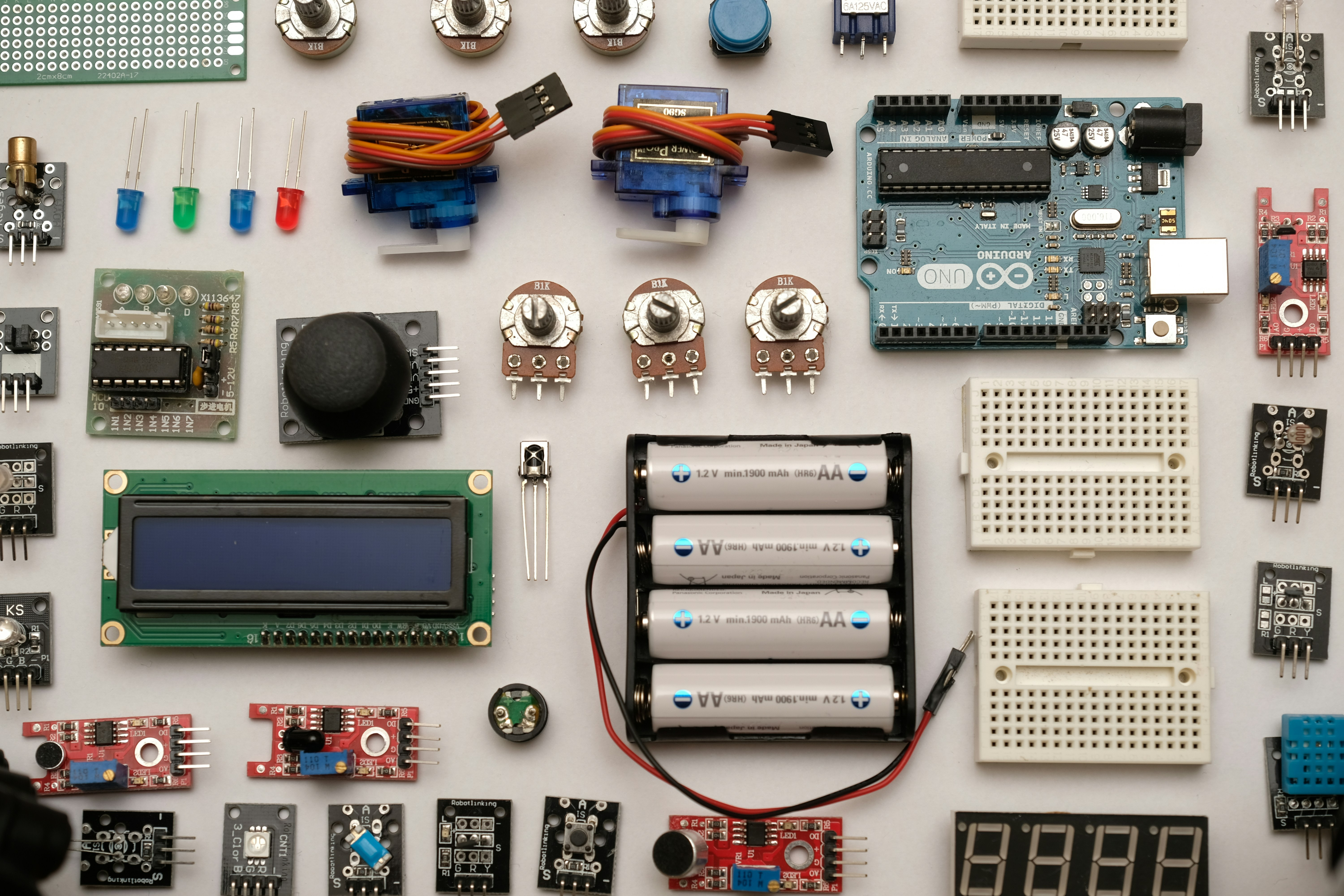 IoT hardware components laid out on a white surface