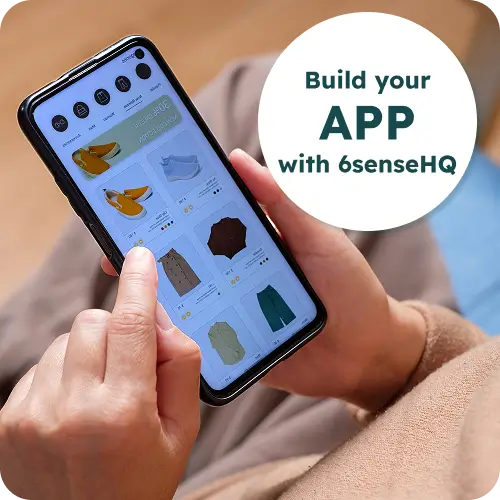 Hand holding a smartphone running a shopping app, with a “Build your app with 6sense HQ” badge