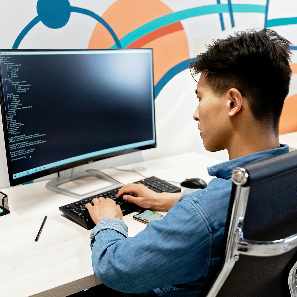 Developer building IoT platform software at a desktop workstation
